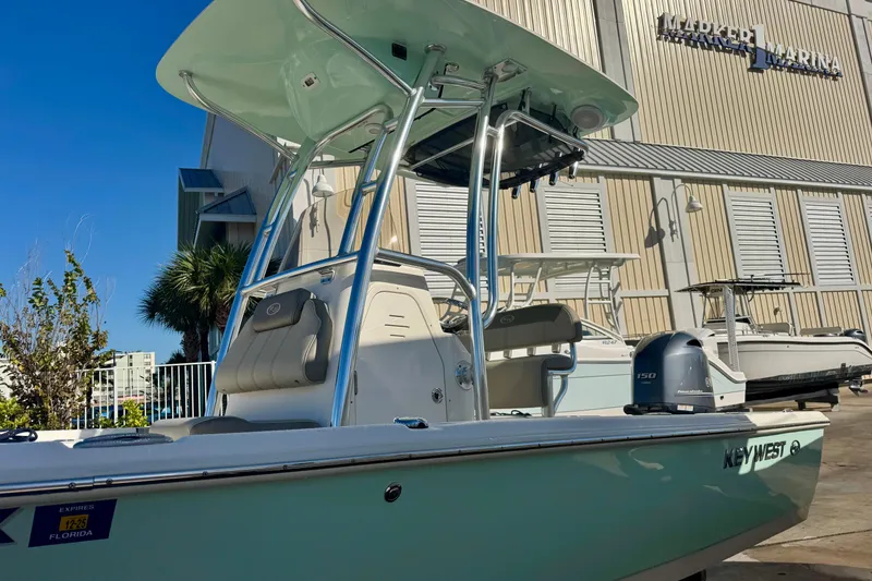 Slide: The Image of 2023 Key West 210 Bay Reef boat docked at a marina under clear blue skies. - 8