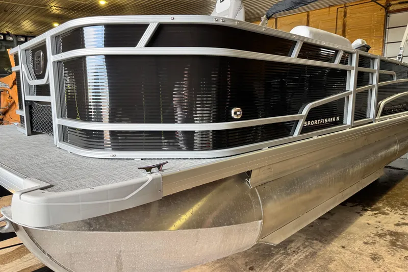 The Image of 2026 Princecraft Sportfisher 23-2S RL pontoon boat in a garage setting. - 0