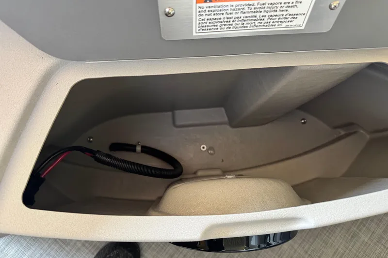 Slide: The Image of Storage compartment of 2026 Princecraft Sportfisher 23-2S RL boat, featuring wiring and safety label. - 10