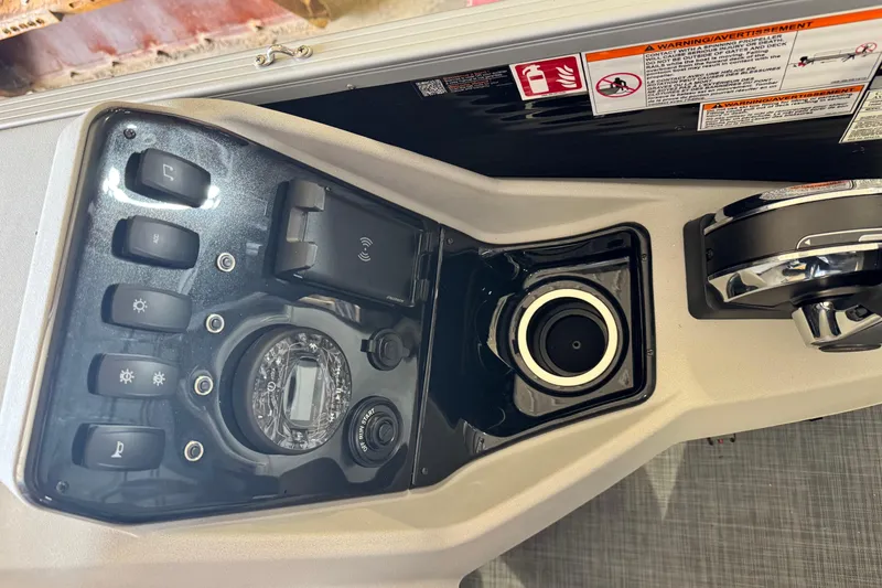 Slide: The Image of 2026 Princecraft Sportfisher 23-2S RL dashboard with controls and warning labels. - 11