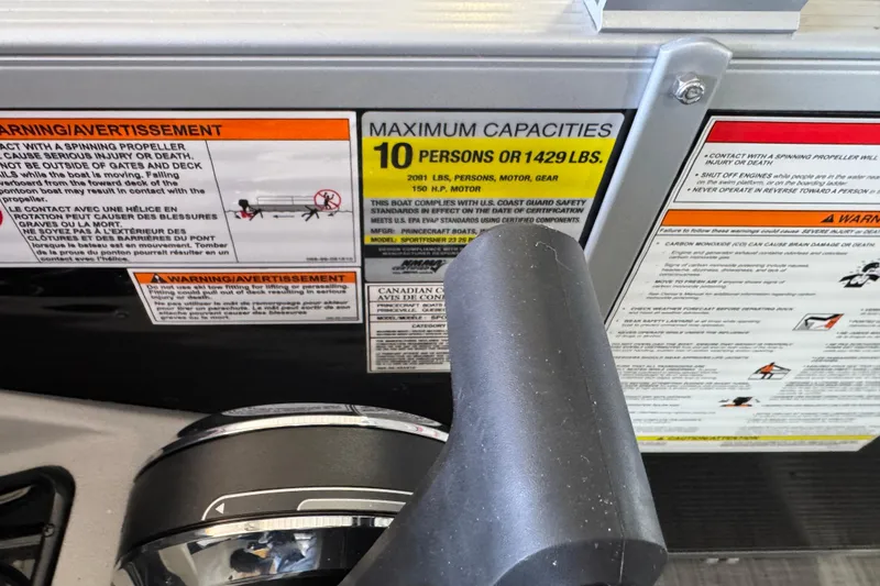 Slide: The Image of Warning labels on a 2026 Princecraft Sportfisher 23-2S RL boat, showing maximum capacity details. - 12