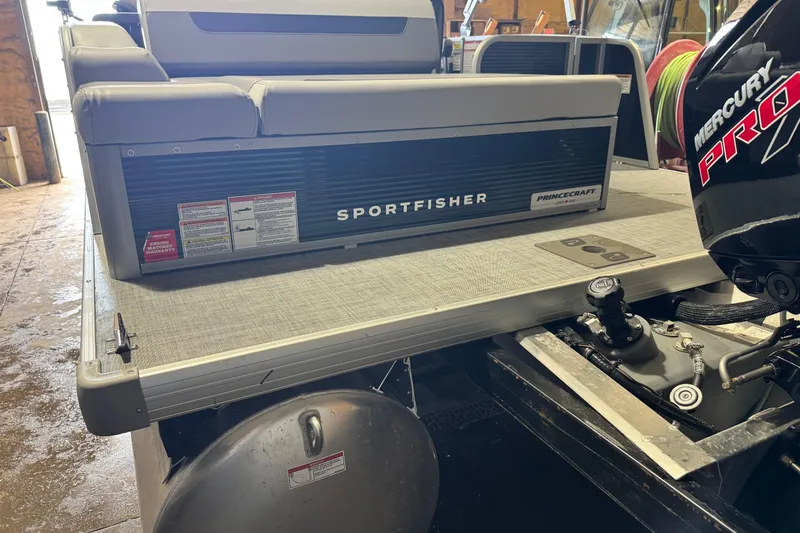 Slide: The Image of 2026 Princecraft Sportfisher 23-2S RL boat with Mercury Pro motor in a garage setting. - 16