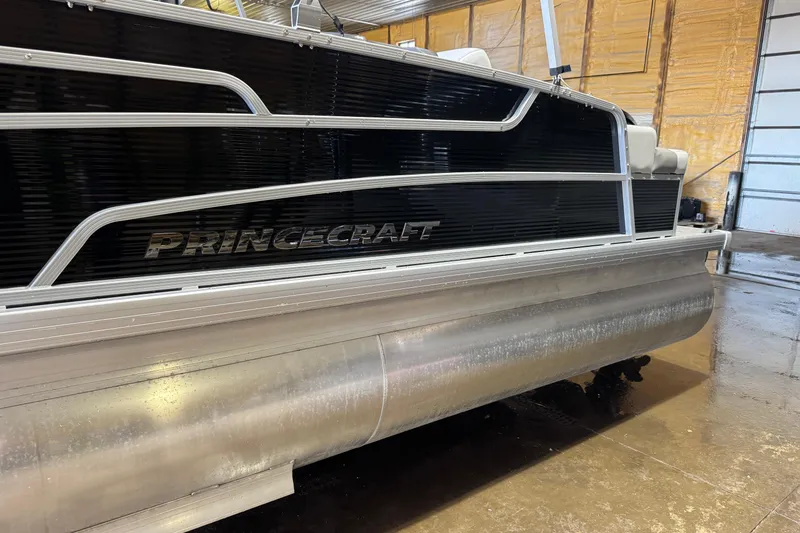 Slide: The Image of 2026 Princecraft Sportfisher 23-2S RL pontoon boat in a garage setting. - 17