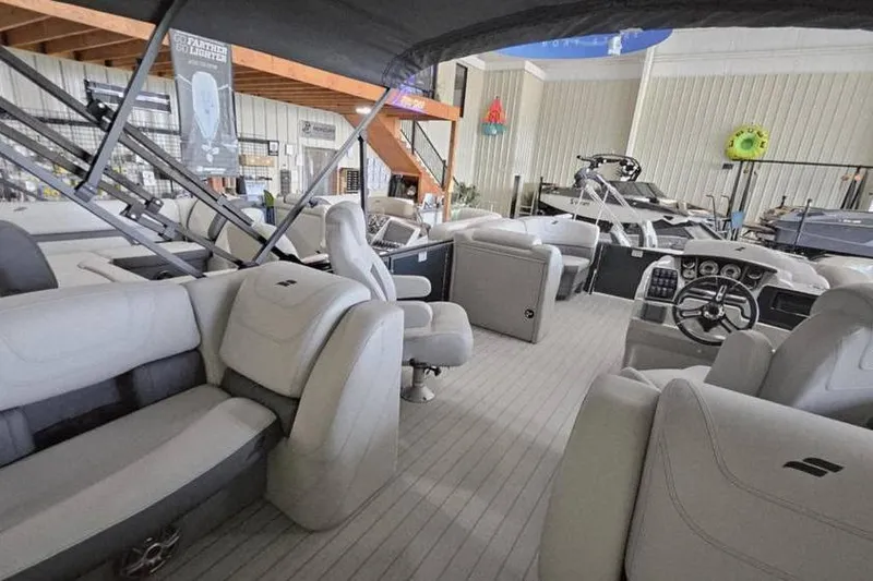 Slide: The Image of 2024 Starcraft SLS 3 boat interior with luxurious seating and modern dashboard in showroom. - 7