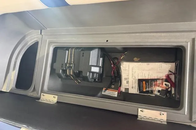 Slide: The Image of Storage compartment of 2026 Princecraft Jazz 170 boat with battery and manuals. - 11