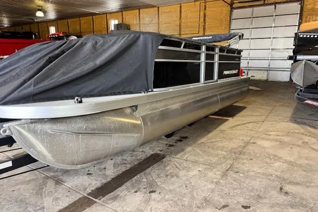 Slide: The Image of 2026 Princecraft Jazz 190-4S pontoon boat in storage, partially covered, indoor setting. - 3