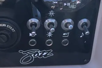 Slide: The Image of Control panel of 2026 Princecraft Jazz 190-4S boat with switches and logo. - 9