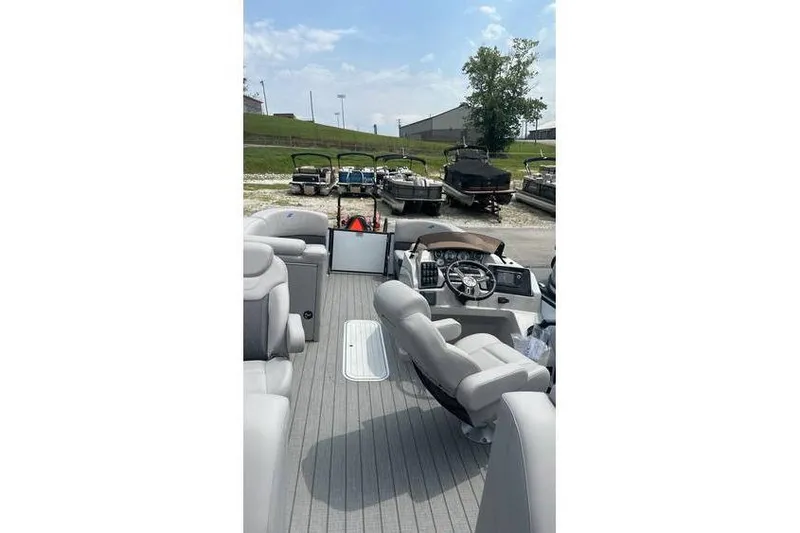 Slide: The Image of 2024 Starcraft SLS 3 pontoon boat interior with steering console and seating. - 3