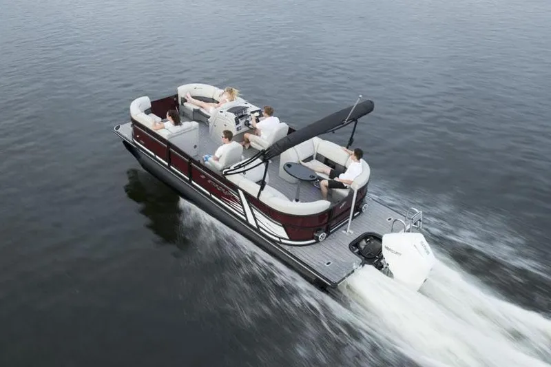 Slide: The Image of Manufacturer Provided Image: 2024 Starcraft SLS 3 pontoon boat cruising on a lake with passengers. - 5