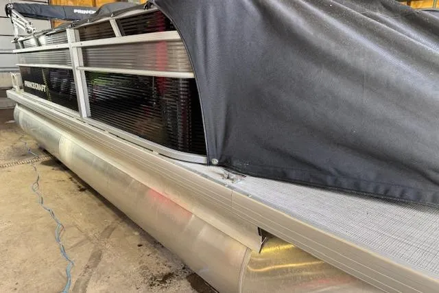 Slide: The Image of 2026 Princecraft Jazz 210-2S pontoon boat with cover in storage. - 4
