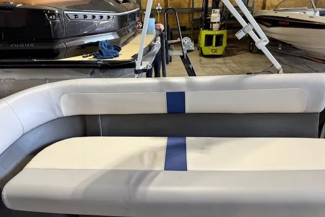 Slide: The Image of 2026 Princecraft Jazz 210-2S boat interior with white and blue seating in a storage area. - 9