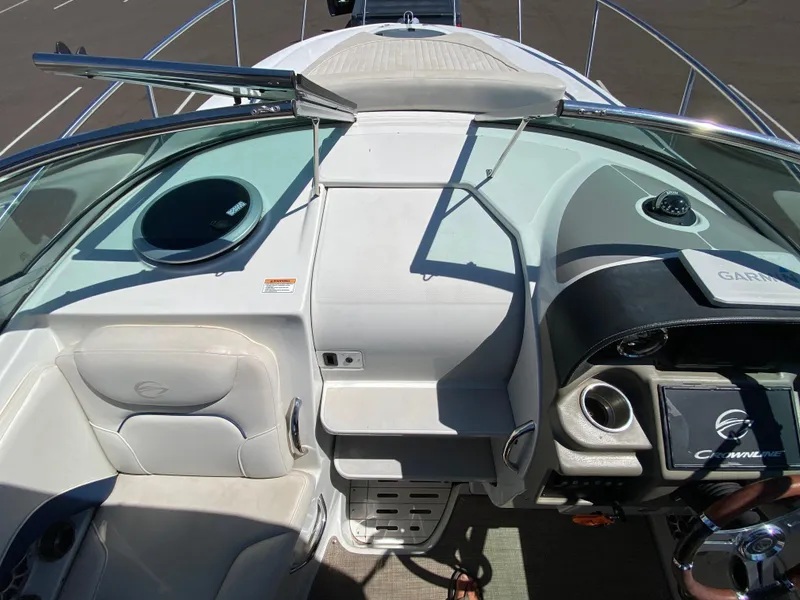 Slide: The Image of 2022 Crownline 264 CR boat cockpit with modern controls and seating. - 13