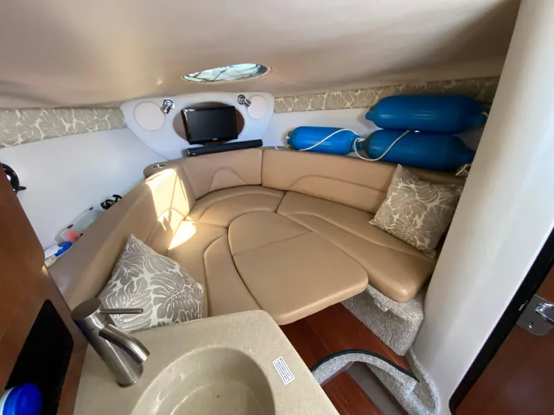Slide: The Image of Interior of 2022 Crownline 264 CR boat with cozy seating and modern amenities. - 22