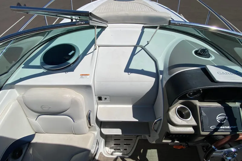 Slide: The Image of 2022 Crownline 264 CR boat cockpit with modern controls and seating. - 44