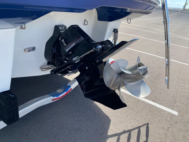 Slide: The Image of Crownline 264 CR 2022 boat propeller and stern drive in parking lot. - 7