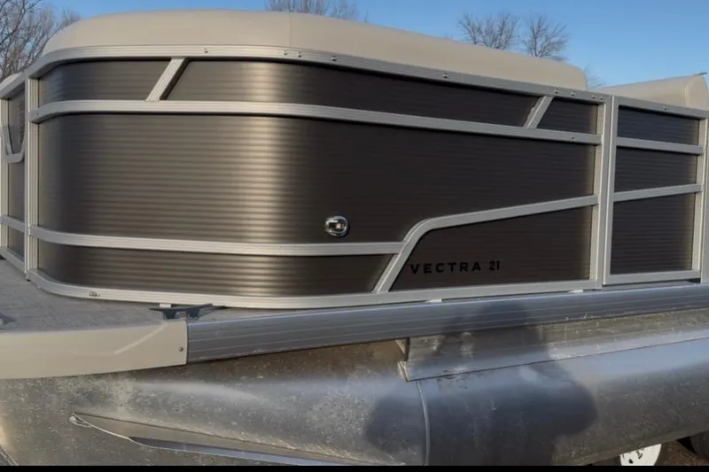 Slide: The Image of 2026 Princecraft Vectra 21 RL pontoon boat with sleek black paneling. - 2