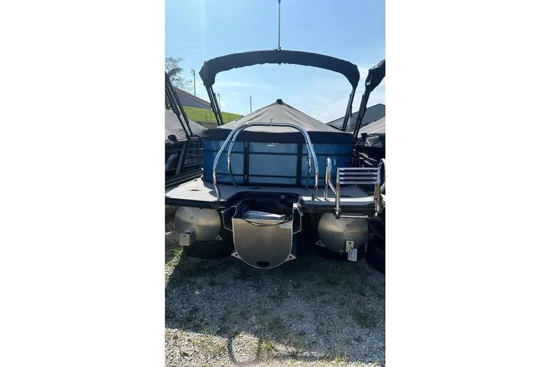 Slide: The Image of 2024 Starcraft EXS 3 pontoon boat, rear view with ladder and canopy. - 2