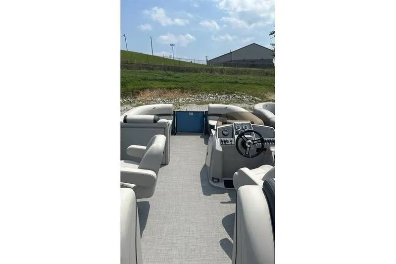 Slide: The Image of 2024 Starcraft EXS 3 pontoon boat interior with steering console and seating. - 4