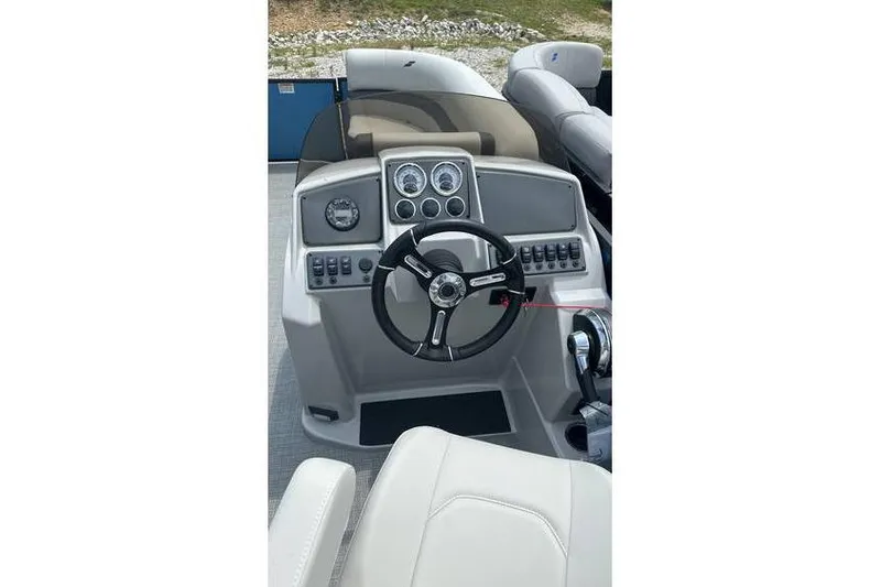 Slide: The Image of 2024 Starcraft EXS 3 boat dashboard with steering wheel and control panel. - 6