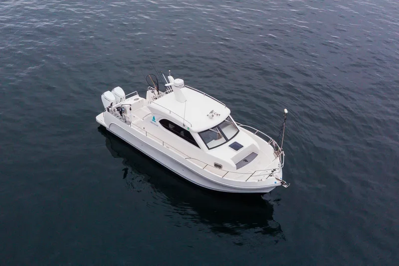 Slide: The Image of 2025 Bracewell Commander 36SF boat on calm water, aerial view. - 1