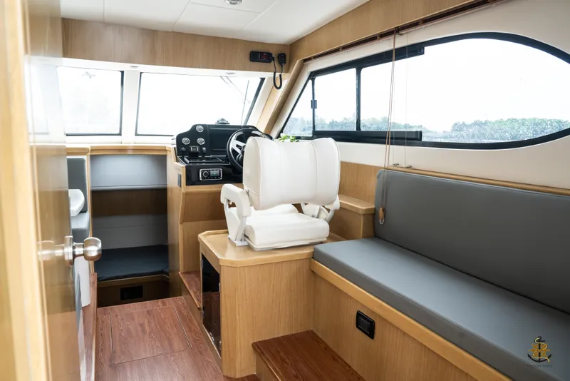 Slide: The Image of Interior of 2025 Bracewell Commander 36SF boat, featuring helm and seating area. - 11