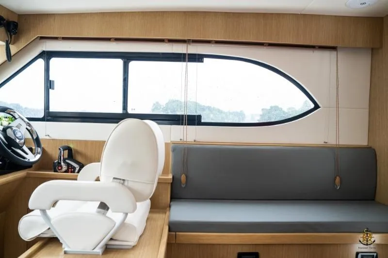 Slide: The Image of Interior of 2025 Bracewell Commander 36SF yacht with modern seating and large window. - 13