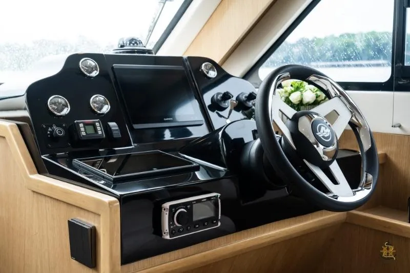 Slide: The Image of Helm of 2025 Bracewell Commander 36SF yacht with modern controls and steering wheel. - 14