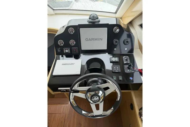 Slide: The Image of Helm of 2025 Bracewell Commander 36SF with Garmin navigation and Mercury controls. - 15