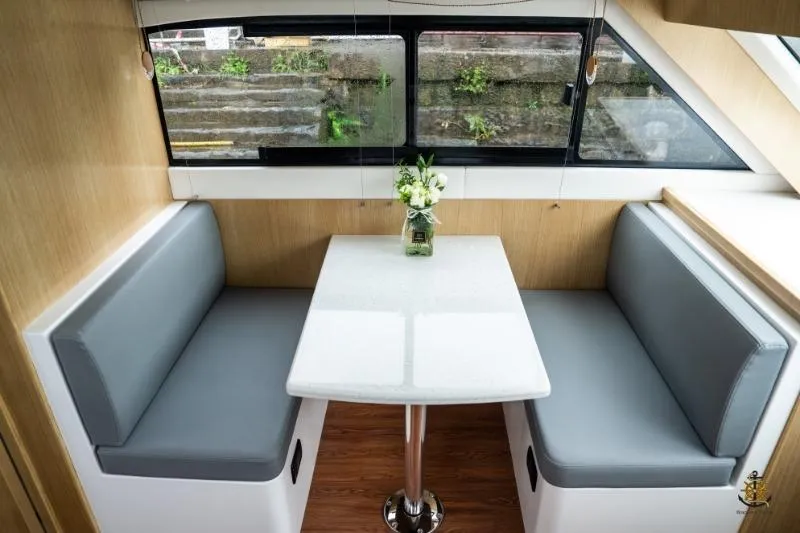 Slide: The Image of Interior of 2025 Bracewell Commander 36SF with dining area and window view. - 16
