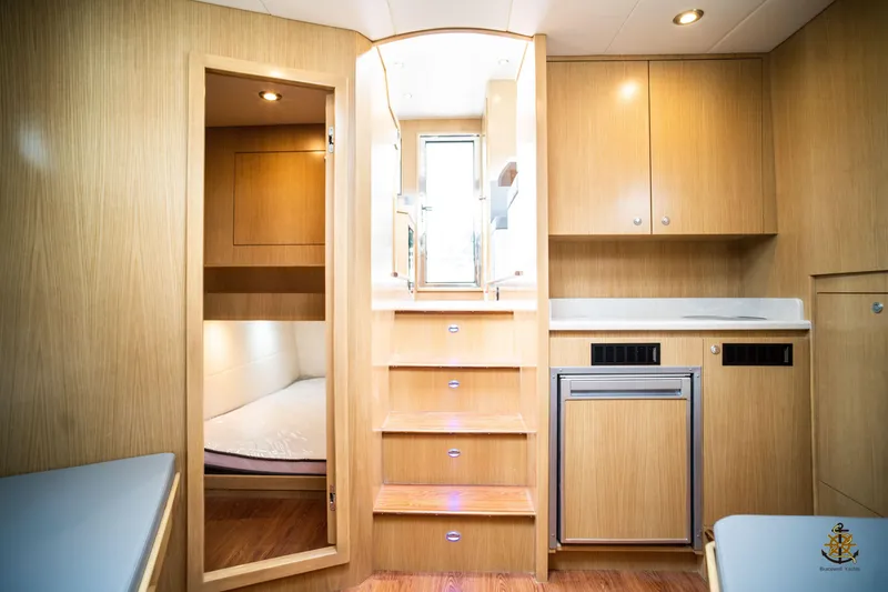 Slide: The Image of Interior of 2025 Bracewell Commander 36SF yacht with wooden cabinetry and compact kitchen. - 17