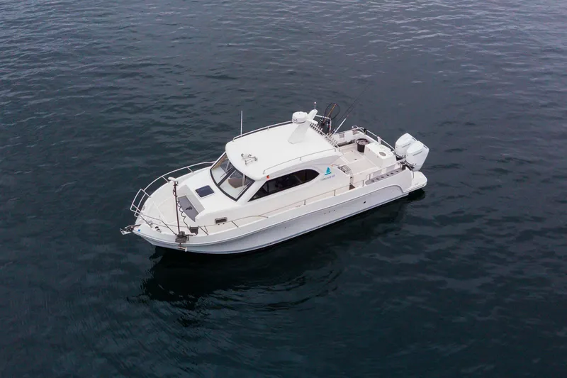 Slide: The Image of 2025 Bracewell Commander 36SF boat on calm water, aerial view. - 2