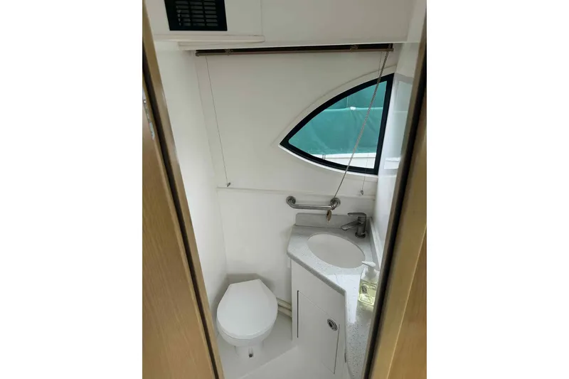 Slide: The Image of Compact bathroom in 2025 Bracewell Commander 36SF boat with modern fixtures and oval window. - 20