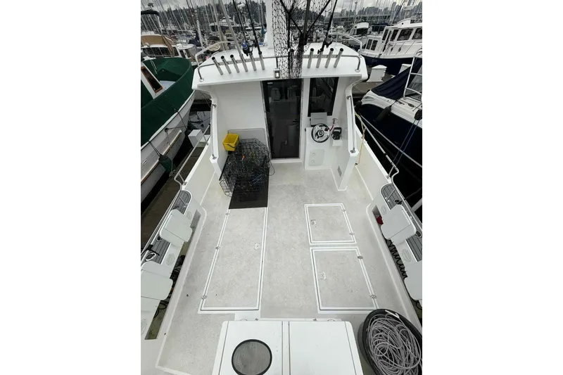 Slide: The Image of 2025 Bracewell Commander 36SF boat deck with fishing gear and storage compartments. - 22