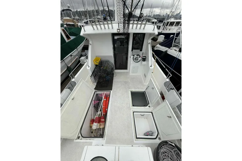 Slide: The Image of 2025 Bracewell Commander 36SF boat deck with storage compartments and fishing gear. - 23