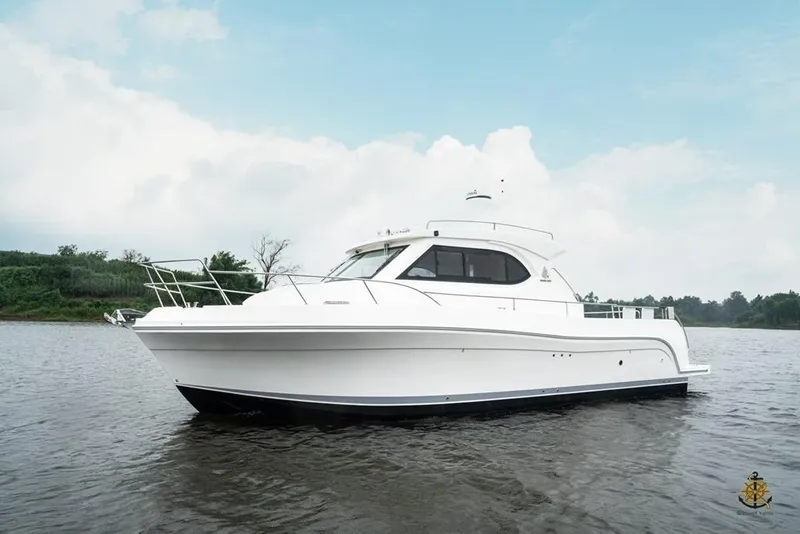 Slide: The Image of 2025 Bracewell Commander 36SF yacht on calm water under a cloudy sky. - 6