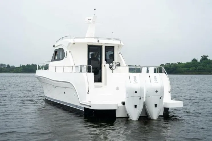 Slide: The Image of 2025 Bracewell Commander 36SF boat with dual engines on a calm waterway. - 7