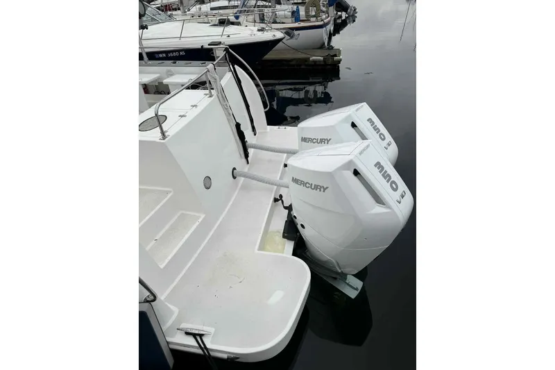 Slide: The Image of 2025 Bracewell Commander 36SF with dual Mercury outboard engines at a marina. - 8