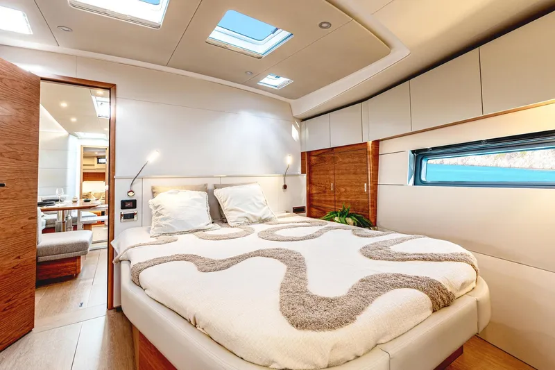 Slide: The Image of Luxurious interior of 2026 Hanse 590 yacht with modern bedroom design and natural lighting. - 15