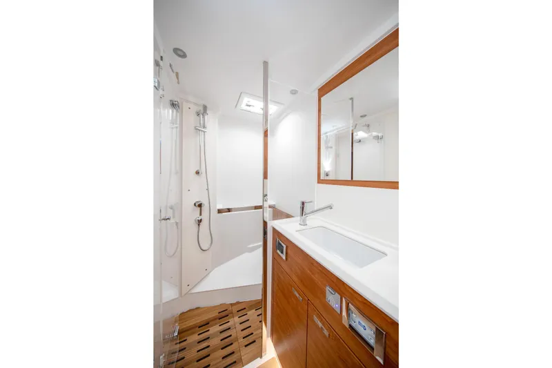 Slide: The Image of Luxurious bathroom in 2026 Hanse 590 yacht with modern fixtures and wooden accents. - 16
