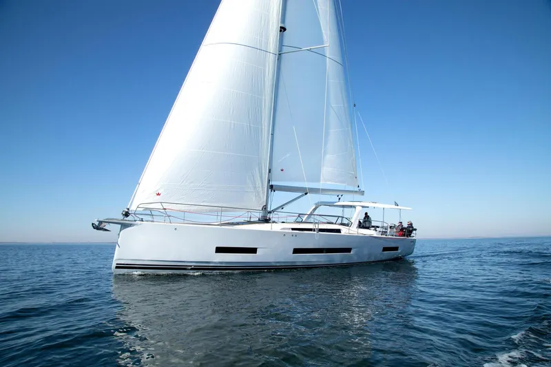 Slide: The Image of Sailing yacht Hanse 590, 2026 model, gliding on calm blue waters. - 22