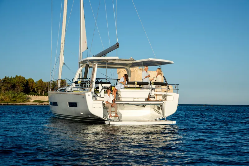 Slide: The Image of 2026 Hanse 590 yacht with people enjoying a sunny day on the water. - 26