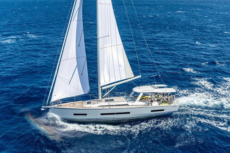 Slide: The Image of 2026 Hanse 590 yacht sailing on open blue ocean waters. - 33