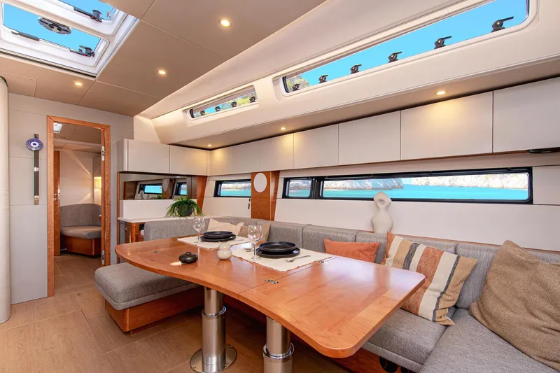 Slide: The Image of Luxurious interior of 2026 Hanse 590 yacht with elegant dining area and scenic windows. - 8