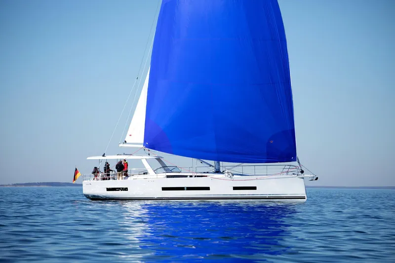 The Image of 2026 Hanse 590 yacht with blue sail on calm sea. - 0