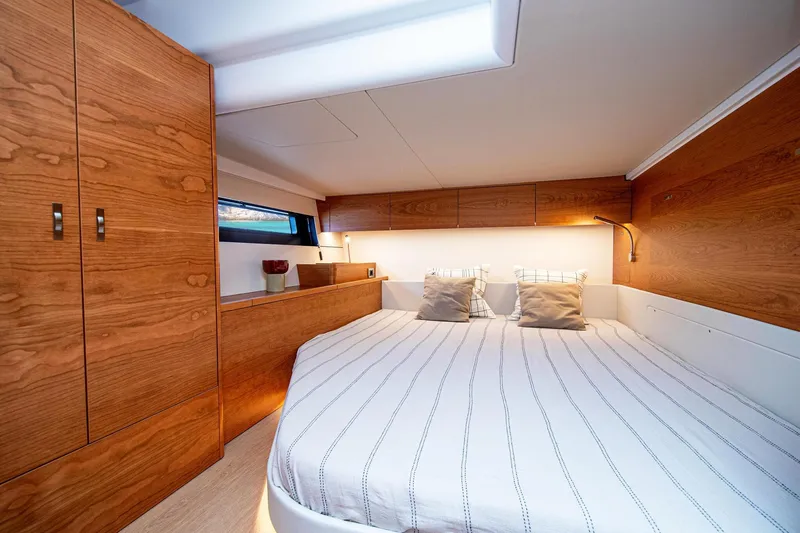 Slide: The Image of Luxurious cabin interior of 2026 Hanse 590 yacht with wood finish and cozy bedding. - 10
