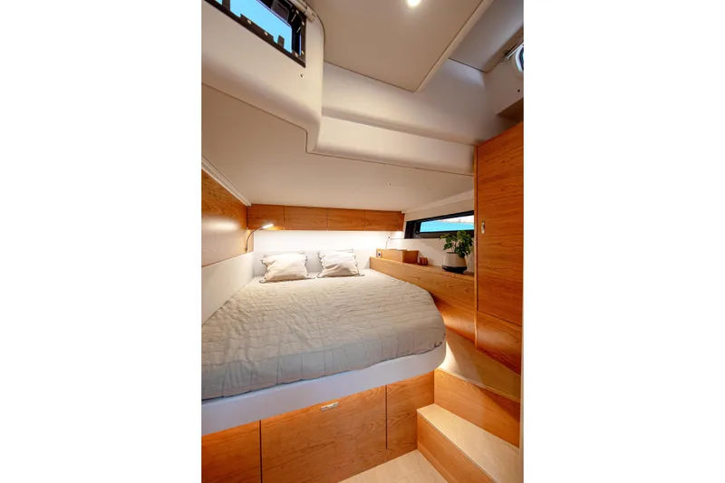 Slide: The Image of Luxurious cabin interior of 2026 Hanse 590 yacht with cozy bed and wooden accents. - 12