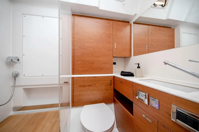 Slide: The Image of Modern bathroom interior on 2026 Hanse 590 yacht, featuring sleek wood cabinetry and contemporary fixtures. - 16