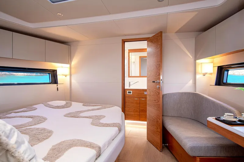 Slide: The Image of Luxurious interior of 2026 Hanse 590 yacht cabin with modern design and cozy furnishings. - 19