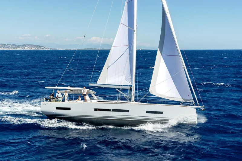 Slide: The Image of Sailing yacht Hanse 590, 2026 model, cruising on open sea with clear skies. - 27