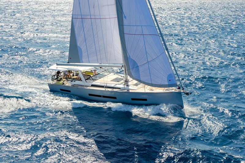 Slide: The Image of 2026 Hanse 590 yacht sailing on open blue ocean waters. - 28